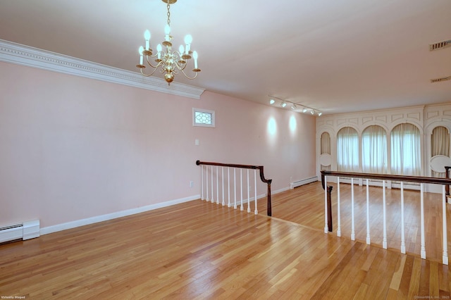 145 Casmir Dr, Fairfield, CT 06825 - empty room with a chandelier, a baseboard radiator, light wood-style floors, and baseboards