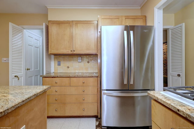 145 Casmir Dr, Fairfield, CT 06825 - kitchen featuring freestanding refrigerator, light brown cabinets, decorative backsplash, and light stone counters