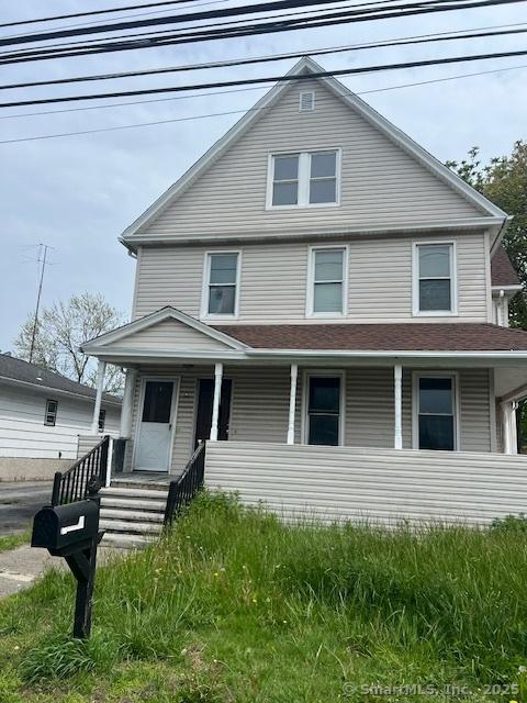 american foursquare style home featuring a porch