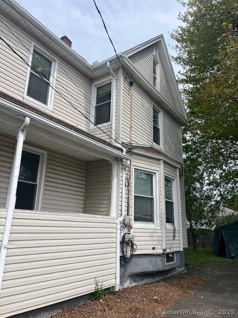 view of property exterior with a chimney