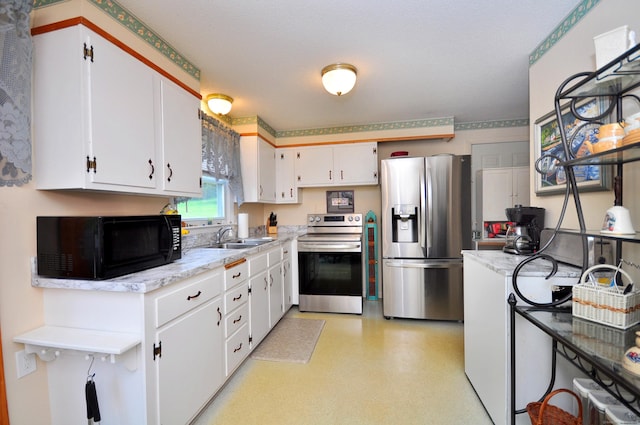 3 Mountain View Dr, Rocky Hill, CT 06067 - kitchen with appliances with stainless steel finishes, white cabinetry, a sink, and light flooring
