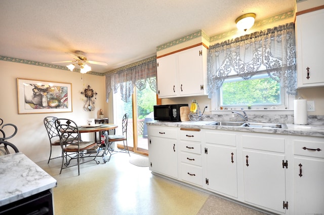 3 Mountain View Dr, Rocky Hill, CT 06067 - kitchen featuring a sink, black microwave, a textured ceiling, white cabinets, and ceiling fan