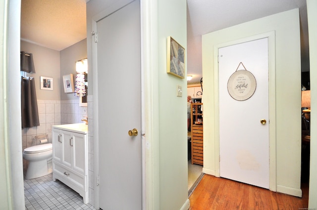 3 Mountain View Dr, Rocky Hill, CT 06067 - hallway with tile walls, wainscoting, and light wood-style floors