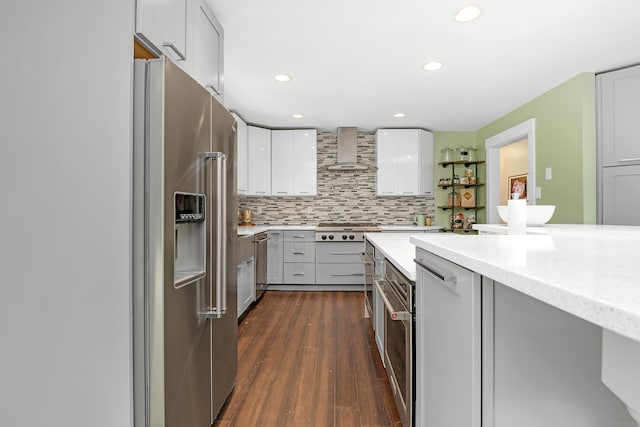 97 W Rd, Marlborough, CT 06447 - kitchen with stainless steel appliances, wall chimney exhaust hood, dark wood-style flooring, white cabinets, and backsplash