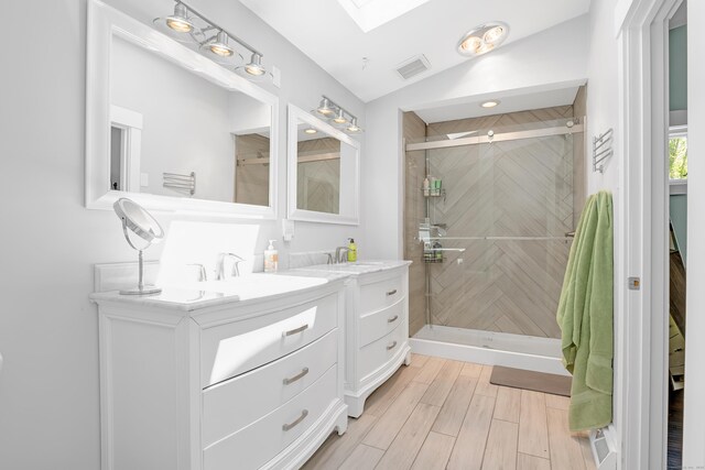 97 W Rd, Marlborough, CT 06447 - bathroom featuring a stall shower, vanity, a skylight, lofted ceiling, and wood finished floors