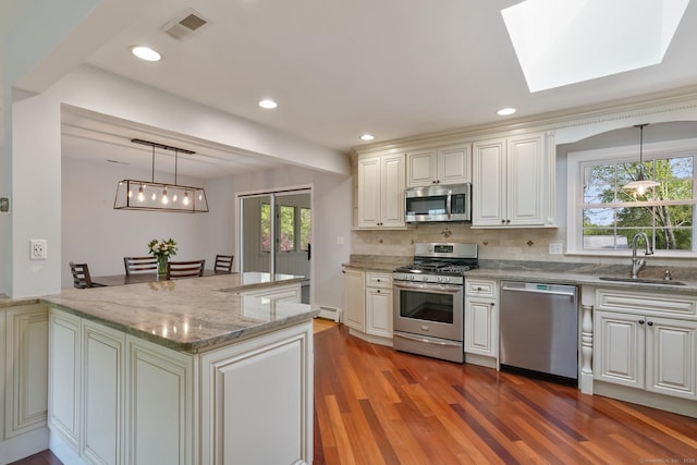 176 Nepas Rd, Fairfield, CT 06825 - kitchen featuring appliances with stainless steel finishes, a sink, wood finished floors, healthy amount of natural light, and recessed lighting