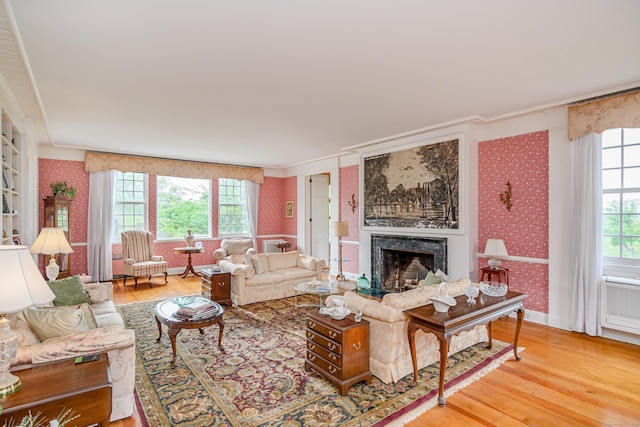 49 Great Ring Rd, Newtown, CT 06482 - living area featuring wallpapered walls, hardwood / wood-style flooring, a premium fireplace, ornamental molding, and healthy amount of natural light