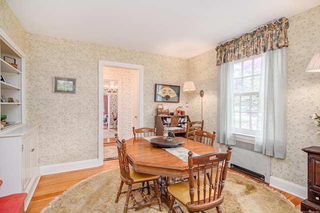 49 Great Ring Rd, Newtown, CT 06482 - dining room with light wood finished floors, a chandelier, and wallpapered walls