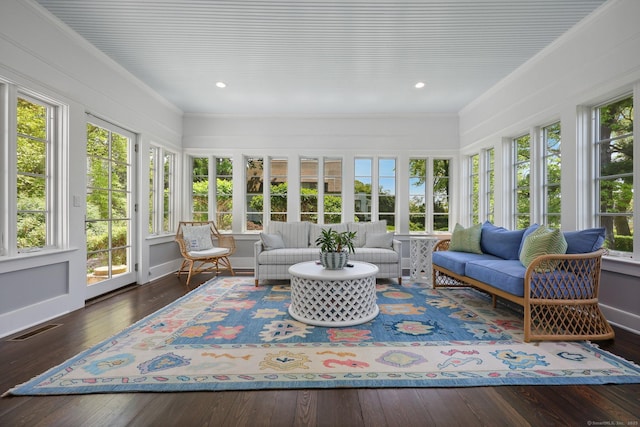 sunroom / solarium with hardwood / wood-style flooring, ornamental molding, and recessed lighting