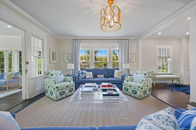 living room featuring ornamental molding, a chandelier, wood finished floors, wainscoting, and recessed lighting