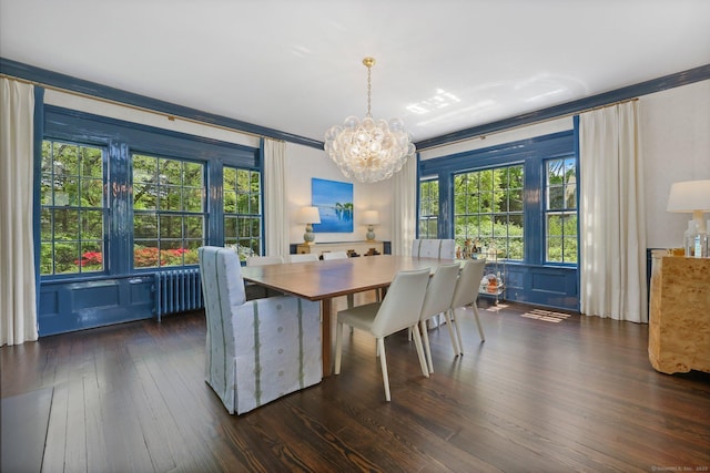 dining room featuring a chandelier, dark wood finished floors, radiator, and ornamental molding