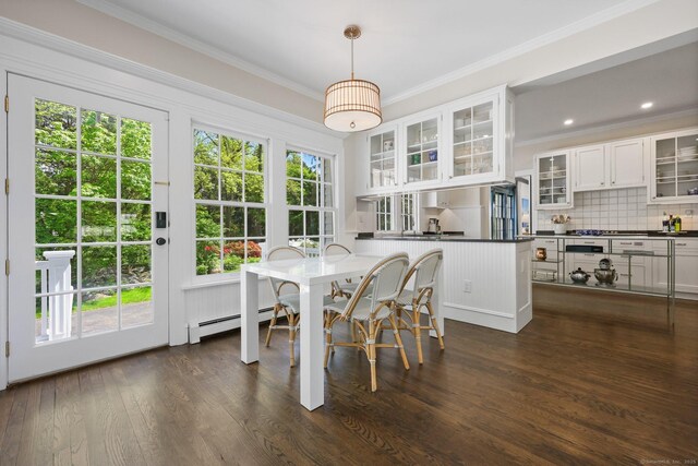 dining area featuring a baseboard radiator, ornamental molding, and dark wood-style flooring
