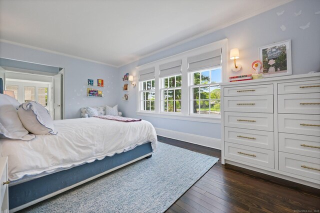 bedroom with ornamental molding, multiple windows, dark wood-style floors, and baseboards