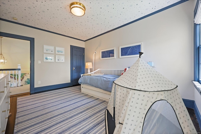 bedroom featuring carpet, crown molding, and baseboards