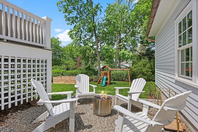 view of patio / terrace with a fire pit and a playground