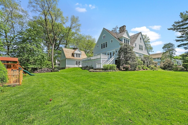 view of grassy yard featuring a playground