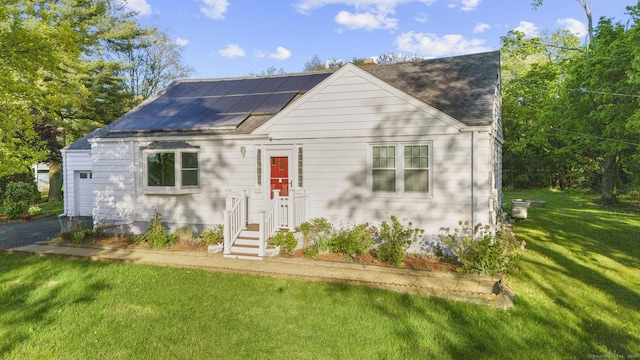 130 Fitch St, North Haven, CT 06473 - new england style home featuring a front yard, solar panels, a shingled roof, and driveway