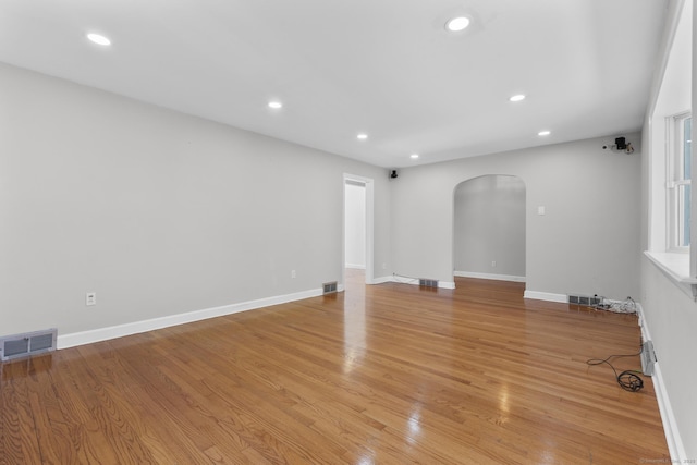 130 Fitch St, North Haven, CT 06473 - unfurnished living room with arched walkways, light wood-style floors, recessed lighting, and baseboards