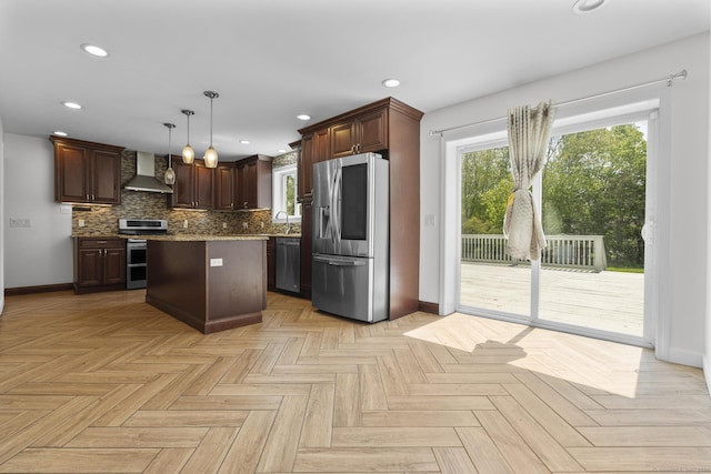 130 Fitch St, North Haven, CT 06473 - kitchen featuring stainless steel appliances, wall chimney exhaust hood, baseboards, tasteful backsplash, and hanging light fixtures