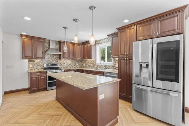 130 Fitch St, North Haven, CT 06473 - kitchen featuring appliances with stainless steel finishes, wall chimney range hood, a sink, backsplash, and light stone countertops
