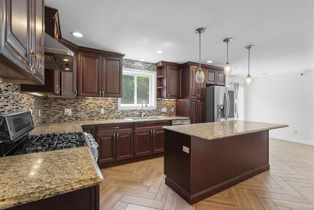 130 Fitch St, North Haven, CT 06473 - kitchen with stainless steel appliances, a sink, a kitchen island, decorative backsplash, and dark brown cabinetry