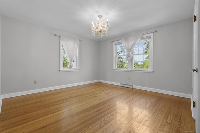 130 Fitch St, North Haven, CT 06473 - spare room featuring a chandelier, plenty of natural light, light wood finished floors, and baseboards