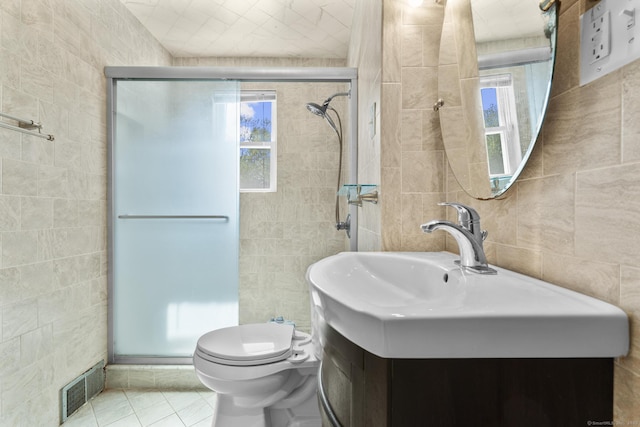130 Fitch St, North Haven, CT 06473 - full bathroom featuring tile walls, healthy amount of natural light, a shower stall, tile patterned flooring, and vanity