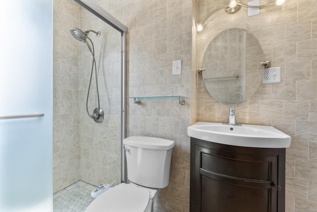 130 Fitch St, North Haven, CT 06473 - bathroom featuring tiled shower, toilet, vanity, and tile walls