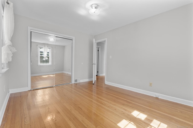 130 Fitch St, North Haven, CT 06473 - unfurnished bedroom featuring light wood-style flooring, a closet, and baseboards