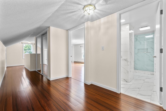 130 Fitch St, North Haven, CT 06473 - additional living space with baseboards, a textured ceiling, and lofted ceiling