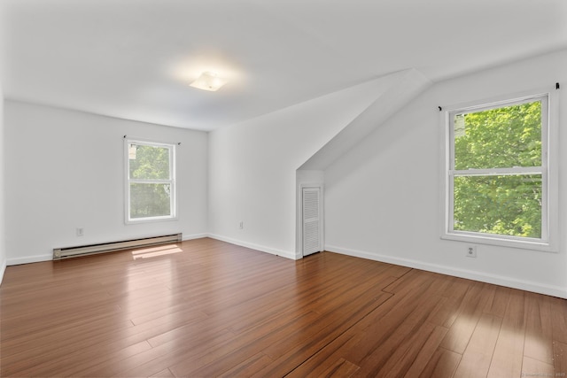 130 Fitch St, North Haven, CT 06473 - additional living space with baseboard heating, wood finished floors, and baseboards