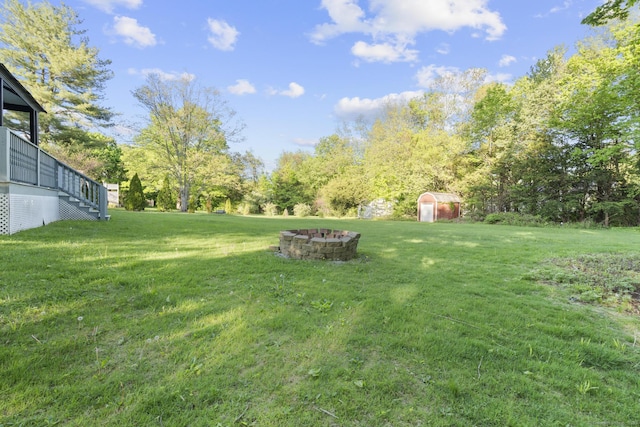 130 Fitch St, North Haven, CT 06473 - view of grassy yard with an outdoor fire pit, a storage unit, an outdoor structure, and stairway