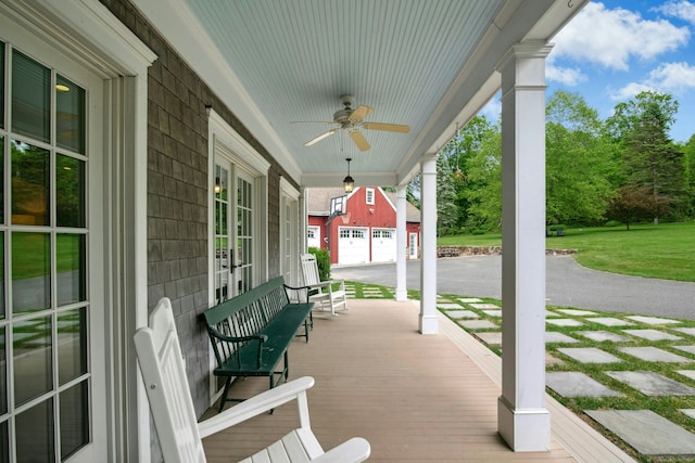 135 Limekiln Rd, Redding, CT 06896 - covered porch with a ceiling fan, an outdoor structure, a garage, and a lawn