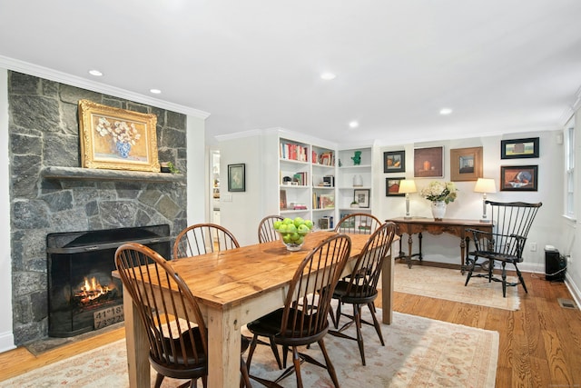 135 Limekiln Rd, Redding, CT 06896 - dining room featuring crown molding, a stone fireplace, wood finished floors, baseboards, and recessed lighting