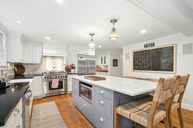 135 Limekiln Rd, Redding, CT 06896 - kitchen with built in appliances, light wood-style flooring, backsplash, ornamental molding, and white cabinetry