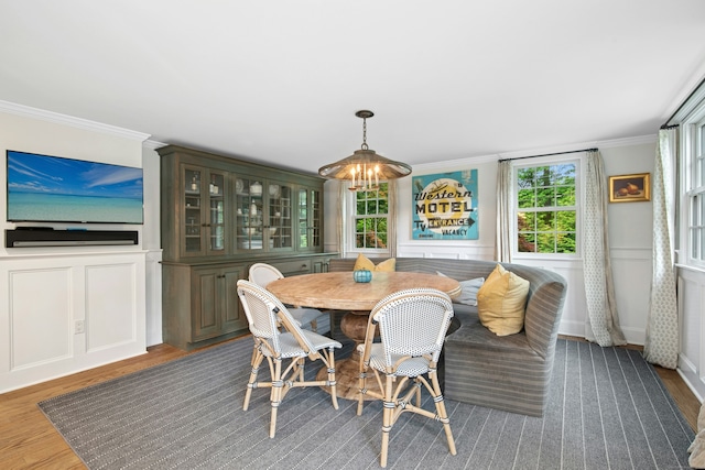 135 Limekiln Rd, Redding, CT 06896 - dining room featuring wood finished floors, crown molding, a decorative wall, and a wainscoted wall