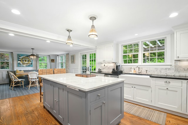 135 Limekiln Rd, Redding, CT 06896 - kitchen featuring gray cabinetry, a sink, a center island, healthy amount of natural light, and crown molding