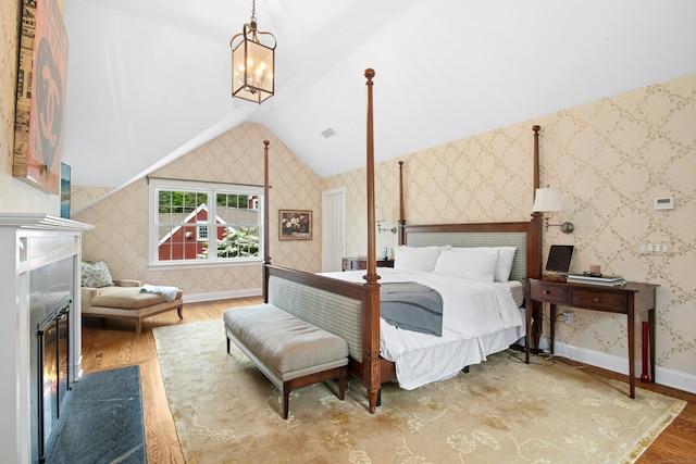 135 Limekiln Rd, Redding, CT 06896 - bedroom with wood finished floors, vaulted ceiling, a high end fireplace, a chandelier, and wallpapered walls