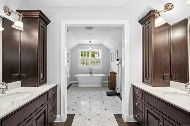 135 Limekiln Rd, Redding, CT 06896 - full bath with lofted ceiling, baseboards, two vanities, and a freestanding bath