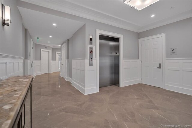 66 High St Unit 40, Guilford, CT 06437 - corridor featuring a decorative wall, elevator, a wainscoted wall, ornamental molding, and recessed lighting