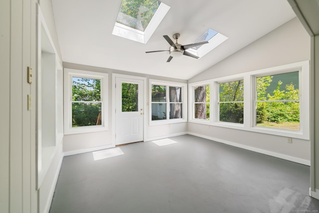 unfurnished sunroom with a skylight, lofted ceiling, finished concrete floors, and baseboards