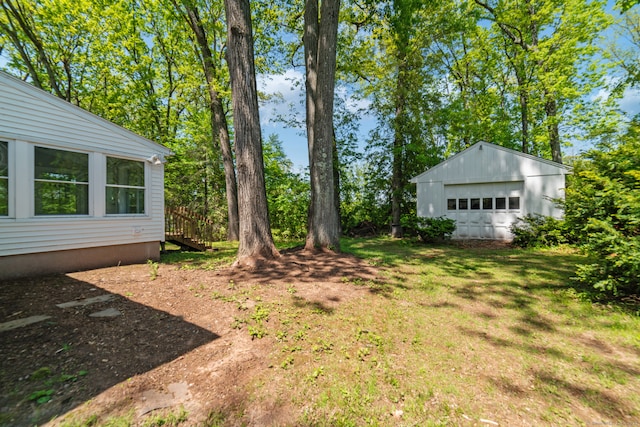 view of yard with an outbuilding and a detached garage