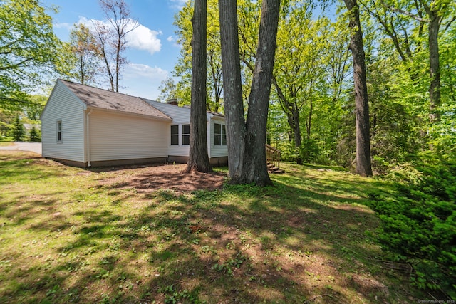 rear view of house with a yard and a chimney