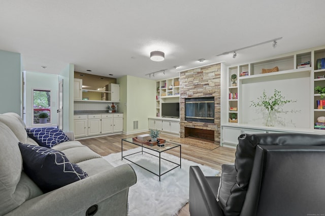 114 Mountain View Rd, Glastonbury, CT 06033 - living area with light wood-style flooring, rail lighting, and a fireplace