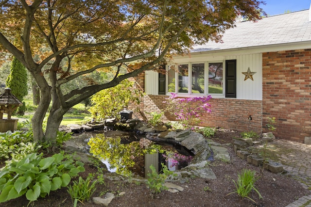 10 Rockwood Ln, Danbury, CT 06811 - view of side of property with brick siding and a garden pond