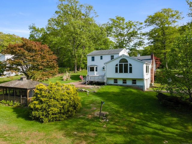 10 Rockwood Ln, Danbury, CT 06811 - back of house with a chimney, a lawn, and a sunroom