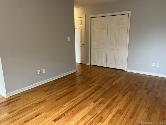 1 Walter Ave Apt 50, Norwalk, CT 06851 - unfurnished bedroom with wood finished floors, baseboards, and a closet