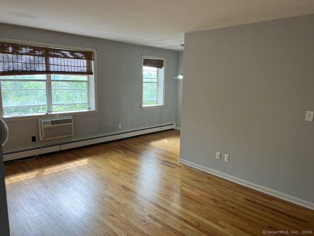 1 Walter Ave Apt 50, Norwalk, CT 06851 - spare room with baseboard heating, wood finished floors, a wall mounted air conditioner, and baseboards