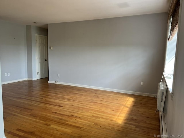 1 Walter Ave Apt 50, Norwalk, CT 06851 - empty room with wood finished floors, baseboards, and a wall mounted AC