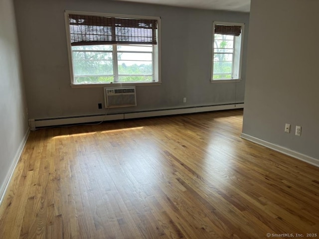 1 Walter Ave Apt 50, Norwalk, CT 06851 - unfurnished room featuring wood finished floors, a wall unit AC, baseboard heating, and baseboards
